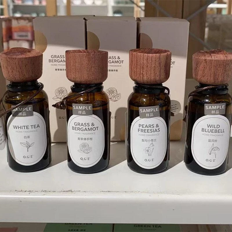 O.C.E. home-fragrance bottles with wooden caps and illustrated labels