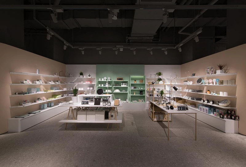 A calm O.C.E. interior with tables and home-object displays