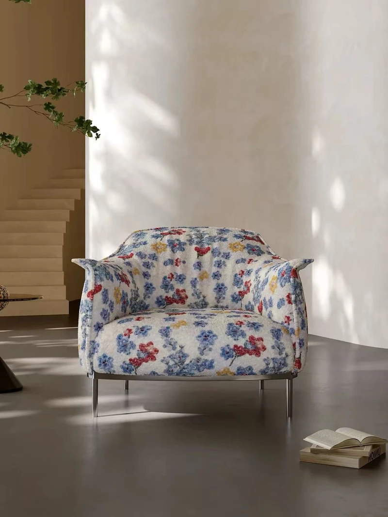 Floral lounge chair with slim metal legs, viewed from the front