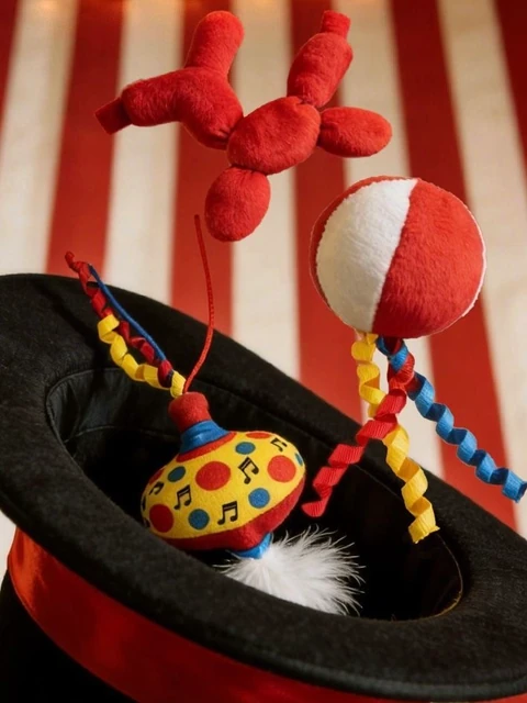 Circus-themed cat toys with bright ribbons and a plush balloon dog