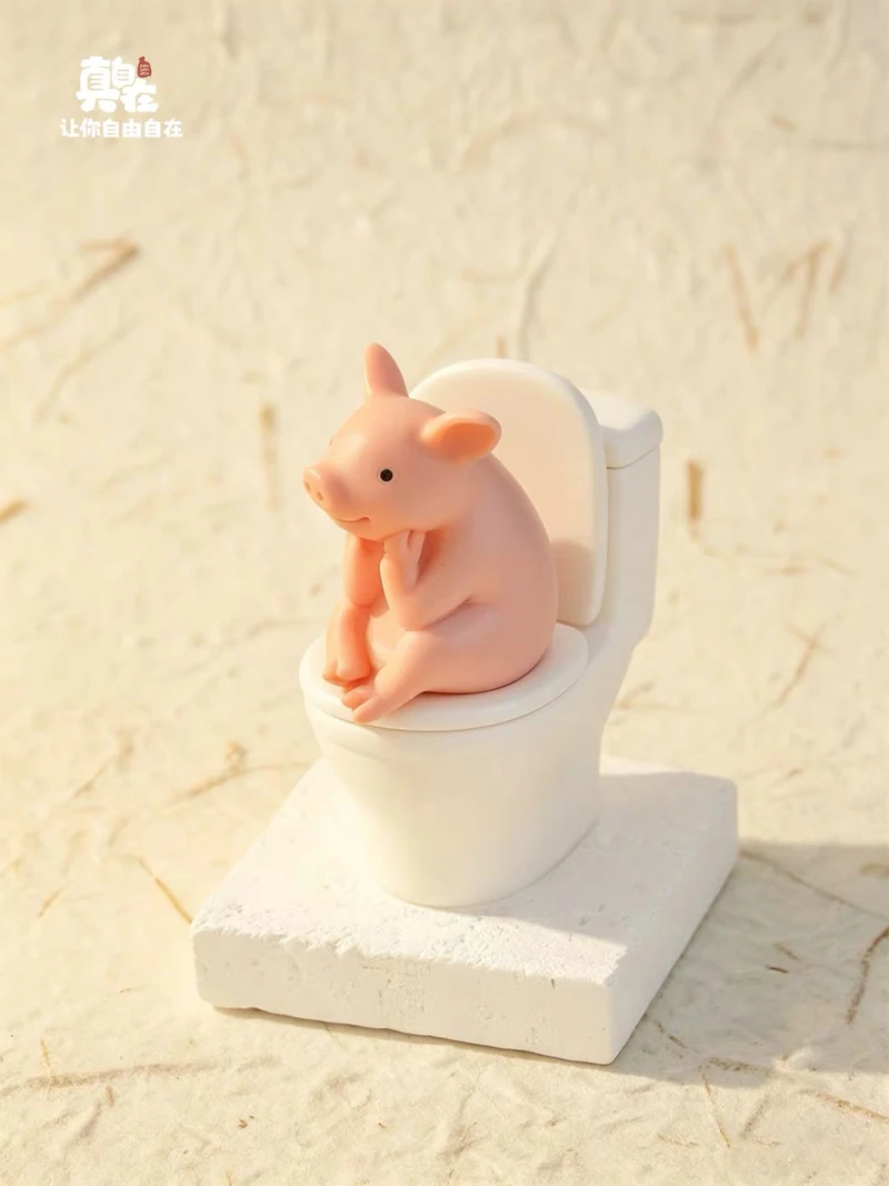 Pink pig figure sitting on a miniature white toilet